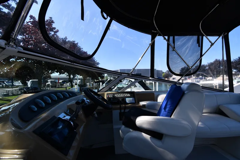 Slide: The Image of Interior view of 2002 Carver 350 Mariner yacht cockpit with steering wheel and seating. - 23