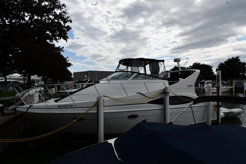 The Image of A 2002 Carver 350 Mariner docked under a cloudy sky. - 0