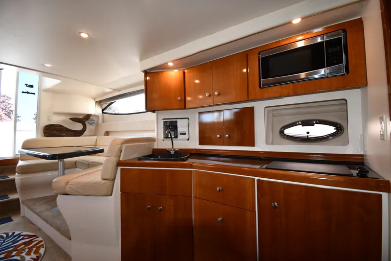 Slide: The Image of Luxurious interior of 2002 Carver 350 Mariner yacht with modern kitchen and seating area. - 48