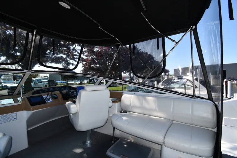 Slide: The Image of Interior view of 2002 Carver 350 Mariner yacht with white seating and helm station. - 24