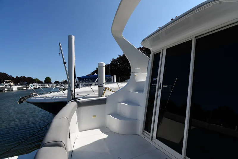 Slide: The Image of 2002 Carver 350 Mariner yacht docked, featuring sleek design and spacious deck area. - 9