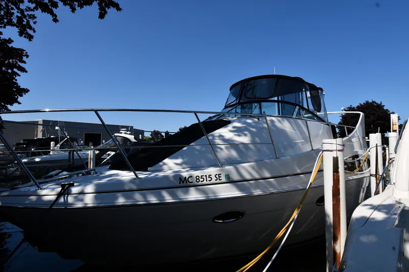 Slide: The Image of 2002 Carver 350 Mariner yacht docked at marina under clear blue sky. - 1