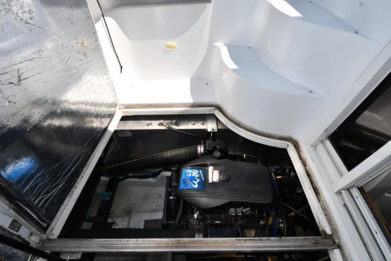 Slide: The Image of Engine compartment of a 2002 Carver 350 Mariner boat, featuring a Mercury engine. - 53