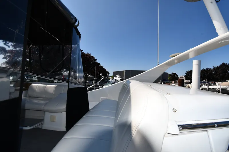 Slide: The Image of 2002 Carver 350 Mariner yacht with white seating and sleek design under clear blue sky. - 15