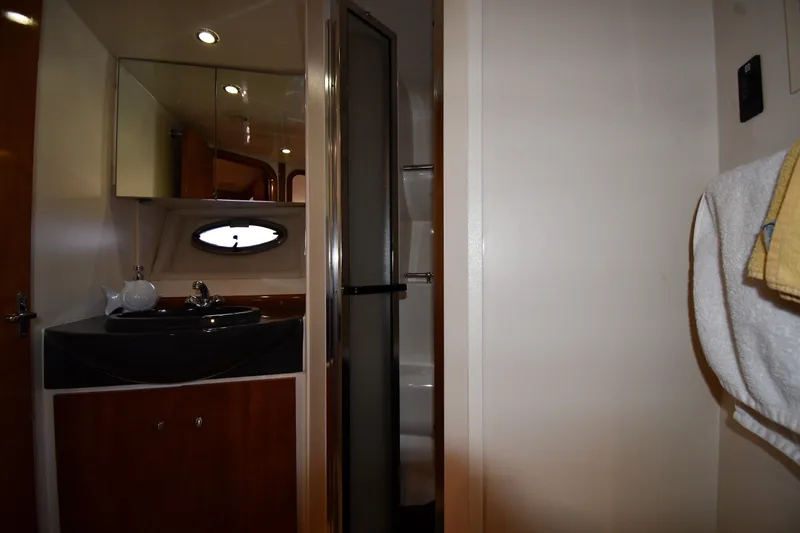 Slide: The Image of Interior of 2002 Carver 350 Mariner bathroom with sink, mirror, and shower. - 36