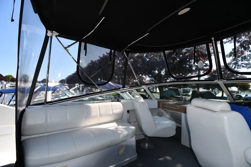 Slide: The Image of Interior view of 2002 Carver 350 Mariner yacht with white seating and panoramic windows. - 25