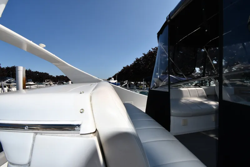 Slide: The Image of 2002 Carver 350 Mariner yacht with white seating and sleek design under clear blue sky. - 16