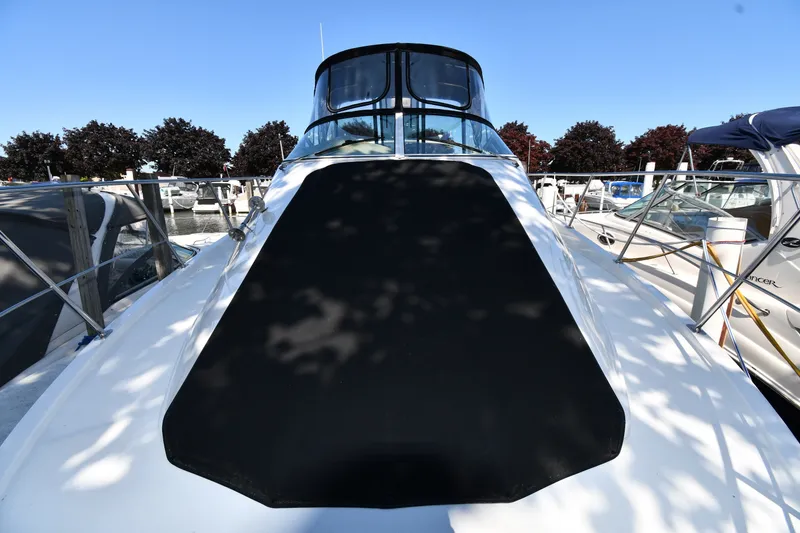 Slide: The Image of 2002 Carver 350 Mariner yacht docked, featuring sleek design and spacious deck. - 5
