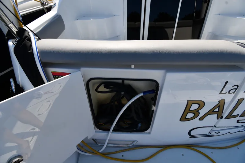 Slide: The Image of Open storage compartment on a 2002 Carver 350 Mariner boat deck. - 11