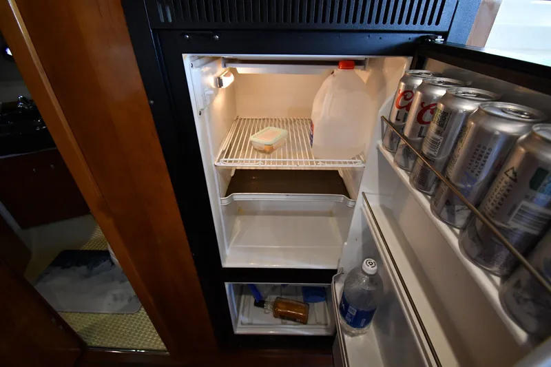Slide: The Image of Open refrigerator in 2002 Carver 350 Mariner yacht, stocked with drinks and essentials. - 47