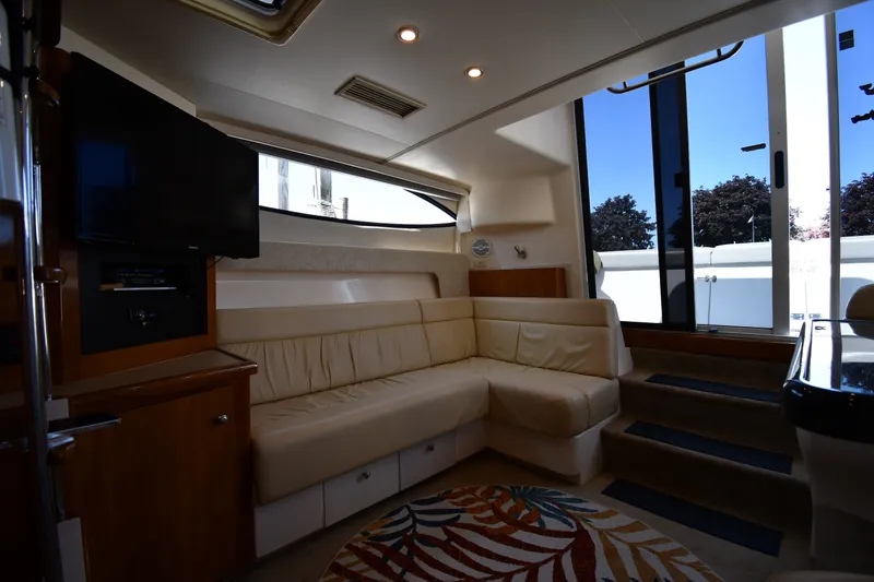 Slide: The Image of Interior of 2002 Carver 350 Mariner yacht with beige seating and TV. - 41