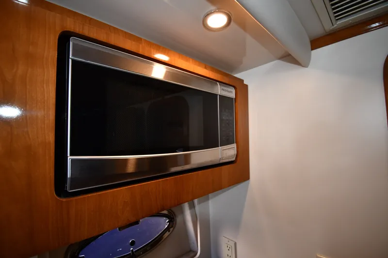 Slide: The Image of Microwave in 2002 Carver 350 Mariner yacht interior, featuring wood paneling and lighting. - 45