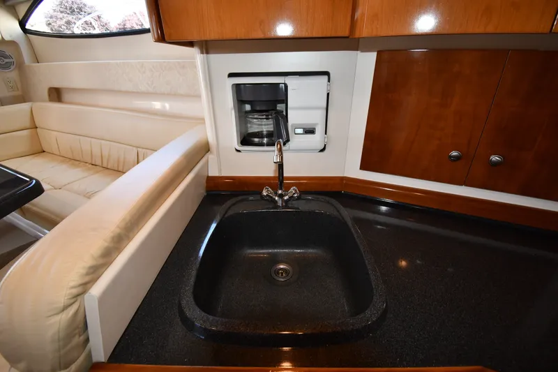Slide: The Image of Interior of 2002 Carver 350 Mariner yacht featuring a kitchen sink and coffee maker. - 43