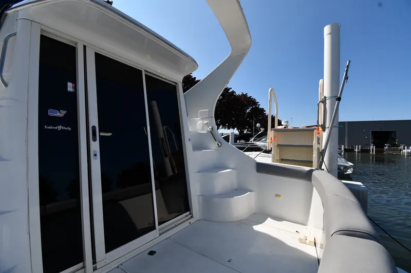 Slide: The Image of 2002 Carver 350 Mariner yacht deck with sliding glass doors and marina view. - 8
