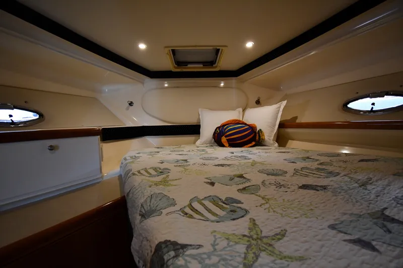 Slide: The Image of Cozy cabin interior of 2002 Carver 350 Mariner with nautical-themed bedding. - 29