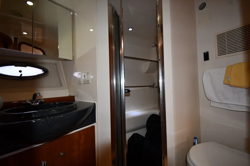 Slide: The Image of 2002 Carver 350 Mariner bathroom with sink, shower, and toilet, featuring modern fixtures. - 37