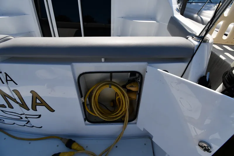 Slide: The Image of Storage compartment on a 2002 Carver 350 Mariner boat with coiled yellow cable. - 10