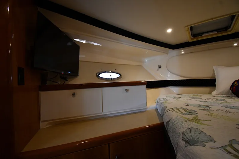 Slide: The Image of Interior cabin of 2002 Carver 350 Mariner with bed, TV, and storage cabinets. - 31
