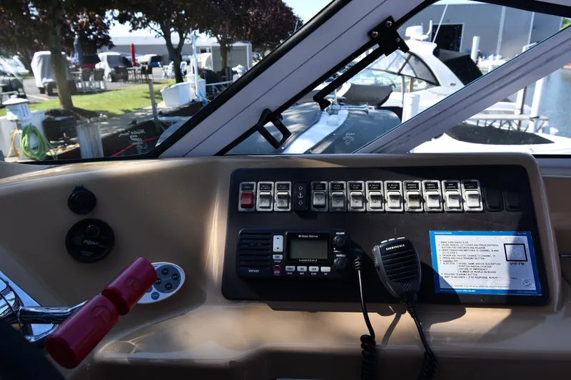 Slide: The Image of Control panel of a 2002 Carver 350 Mariner boat with various switches and equipment. - 20