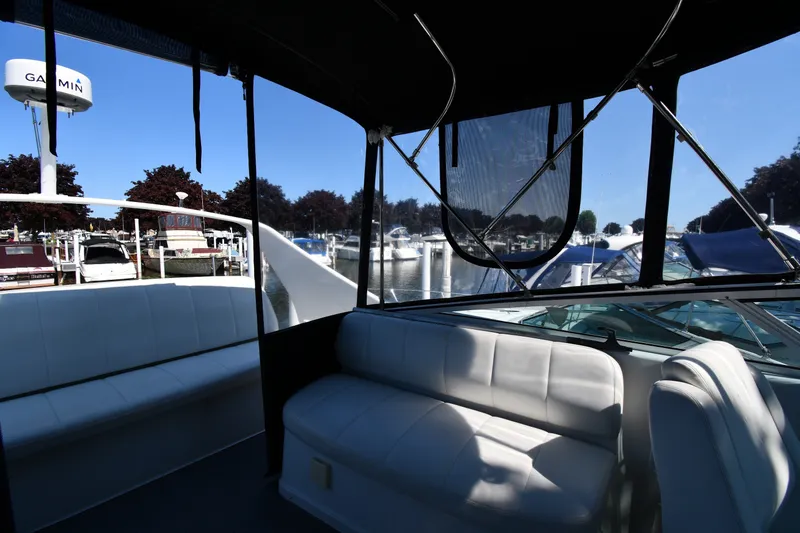Slide: The Image of Interior view of 2002 Carver 350 Mariner yacht at marina, featuring white seating. - 26