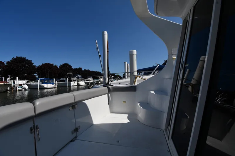 Slide: The Image of 2002 Carver 350 Mariner yacht docked at marina, showcasing sleek design and spacious deck. - 12
