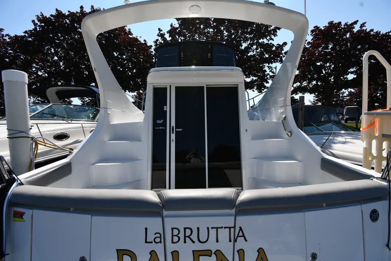 Slide: The Image of 2002 Carver 350 Mariner yacht docked, rear view with stairs and sliding doors. - 7