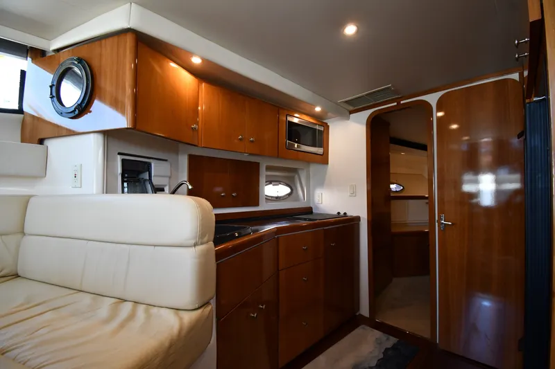 Slide: The Image of Interior of 2002 Carver 350 Mariner yacht with wood cabinetry and plush seating. - 42