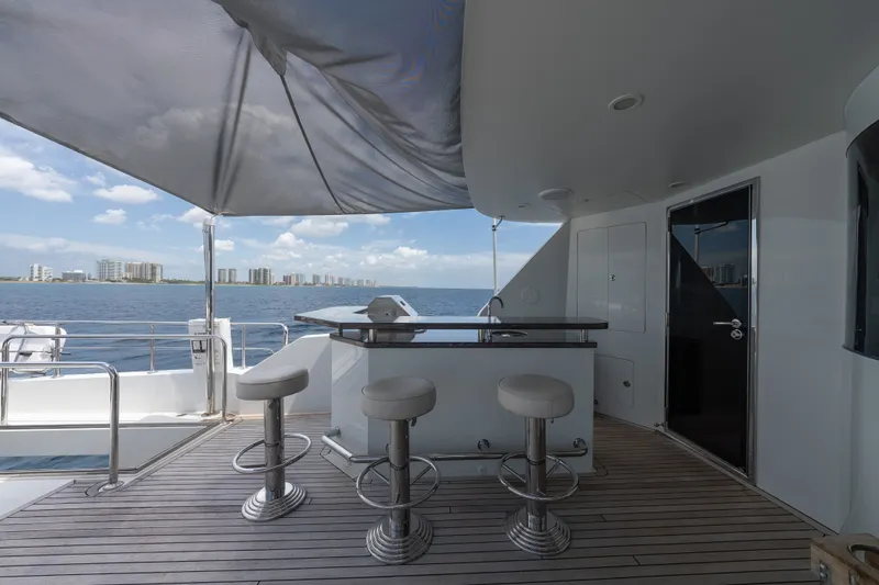 Slide: The Image of Luxurious deck of 2013 Ocean Alexander 90 Skylounge Motoryacht with bar stools and ocean view. - 56