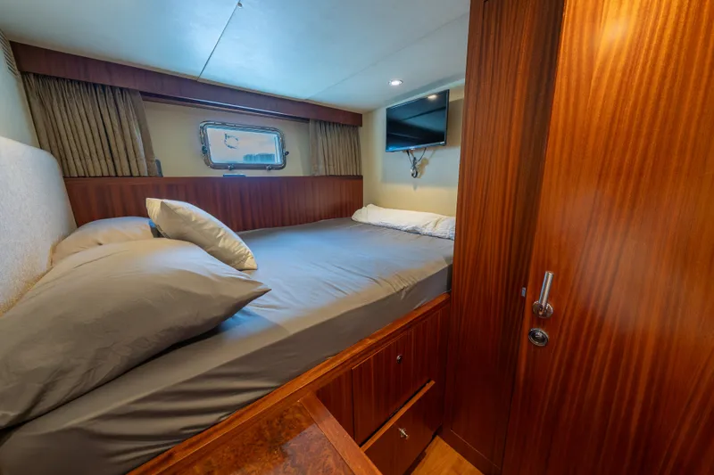 Slide: The Image of Luxurious bedroom in 2013 Ocean Alexander 90 Skylounge Motoryacht with wood paneling and TV. - 47
