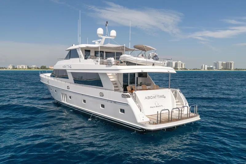 Slide: The Image of 2013 Ocean Alexander 90 Skylounge Motoryacht cruising near a coastal city skyline. - 61