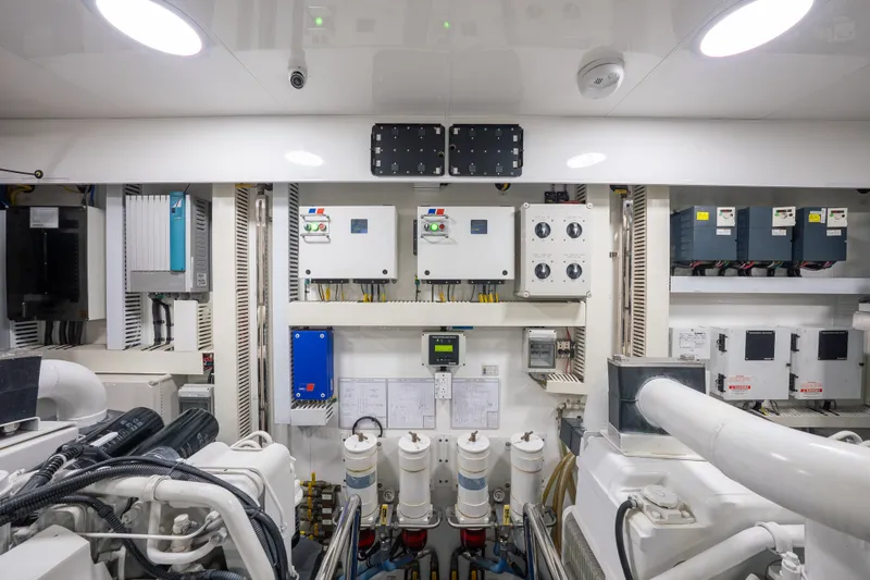 Slide: The Image of Engine room of 2013 Ocean Alexander 90 Skylounge Motoryacht, showcasing control panels and machinery. - 52