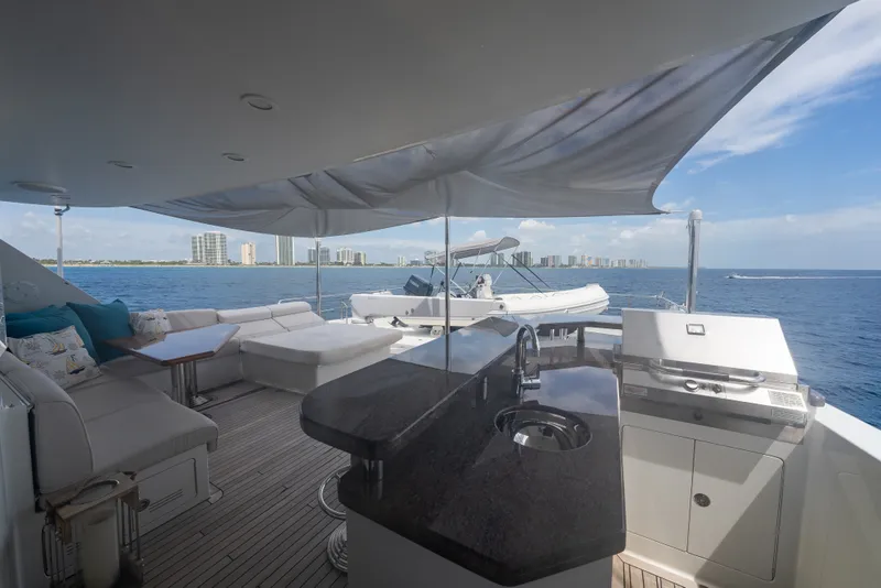 Slide: The Image of Luxurious Ocean Alexander 90 Skylounge Motoryacht deck with seating, grill, and ocean view. - 53