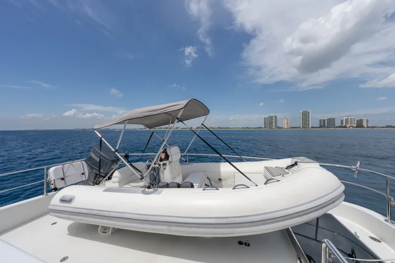 Slide: The Image of Inflatable boat on Ocean Alexander 90 Skylounge Motoryacht, 2013, with city skyline in background. - 58