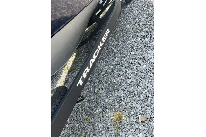 Slide: The Image of 2025 Tracker Pro Guide V-175 SC boat trailer on gravel surface. - 4