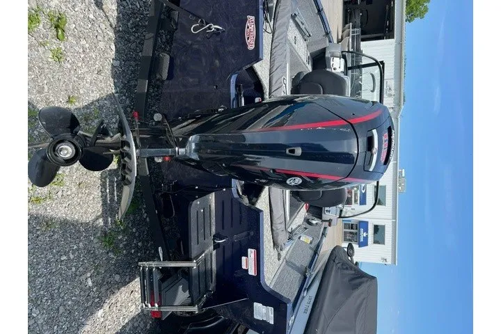 Slide: The Image of 2025 Tracker Pro Guide V-175 SC boat with outboard motor, parked on gravel. - 10