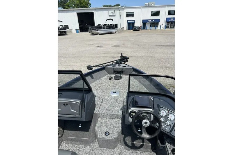Slide: The Image of 2025 Tracker Pro Guide V-175 SC boat interior with steering wheel and control panel. - 16