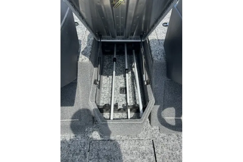 Slide: The Image of 2025 Tracker Pro Guide V-175 SC boat storage compartment with rod holders, open view. - 21