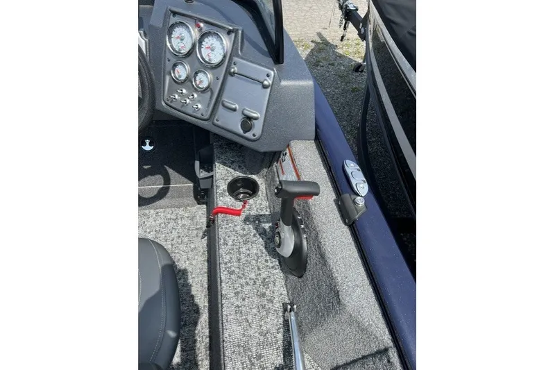 Slide: The Image of 2025 Tracker Pro Guide V-175 SC boat dashboard and controls, featuring gauges and throttle lever. - 15