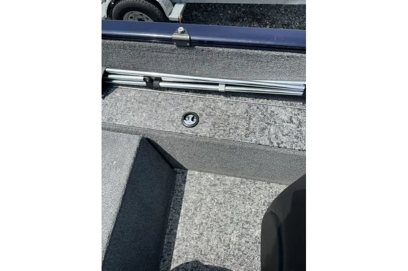 Slide: The Image of 2025 Tracker Pro Guide V-175 SC boat interior with gray carpet and storage compartment. - 22