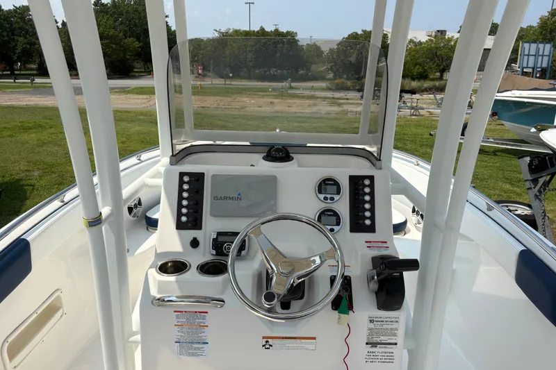 Slide: The Image of 2019 Robalo R222 Center Console boat dashboard with Garmin navigation system and steering wheel. - 3
