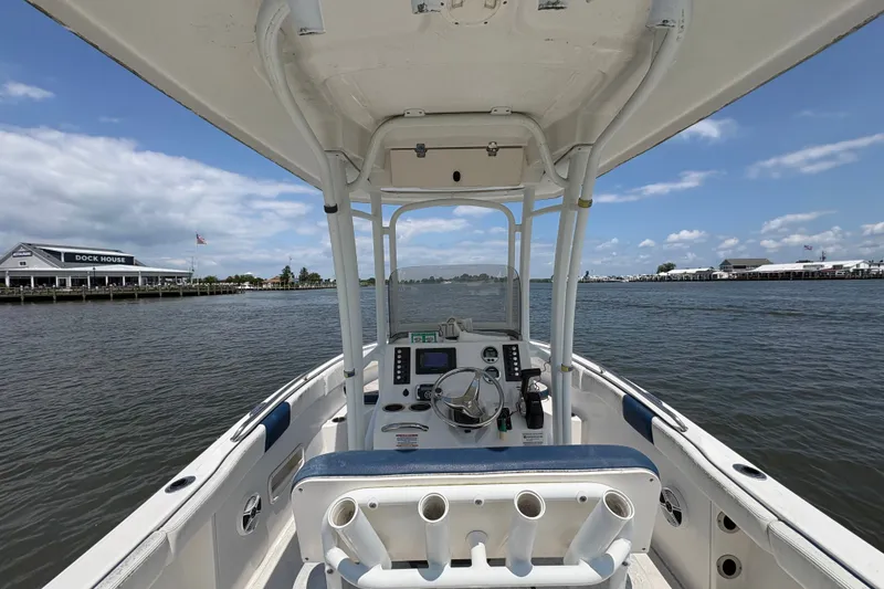 Slide: The Image of 2019 Robalo R222 Center Console boat on calm water near a dock house. - 5