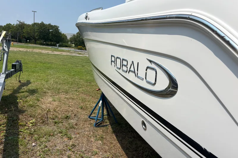 Slide: The Image of 2019 Robalo R222 Center Console boat on grass, side view. - 1