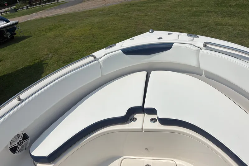 Slide: The Image of 2019 Robalo R222 Center Console boat with cushioned seating on grassy area. - 6