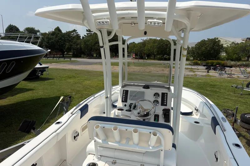Slide: The Image of 2019 Robalo R222 Center Console boat interior with steering wheel and seating. - 2