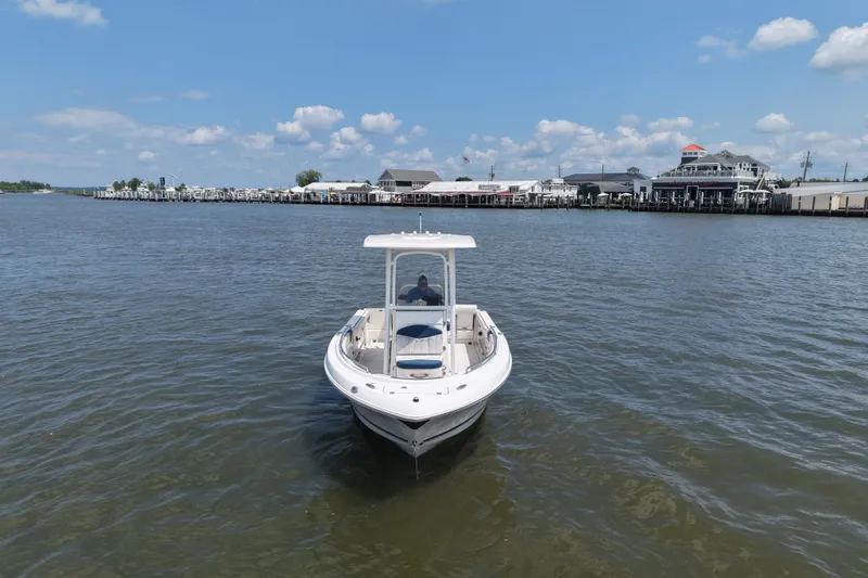 Slide: The Image of 2019 Robalo R222 Center Console boat on calm water near marina. - 2