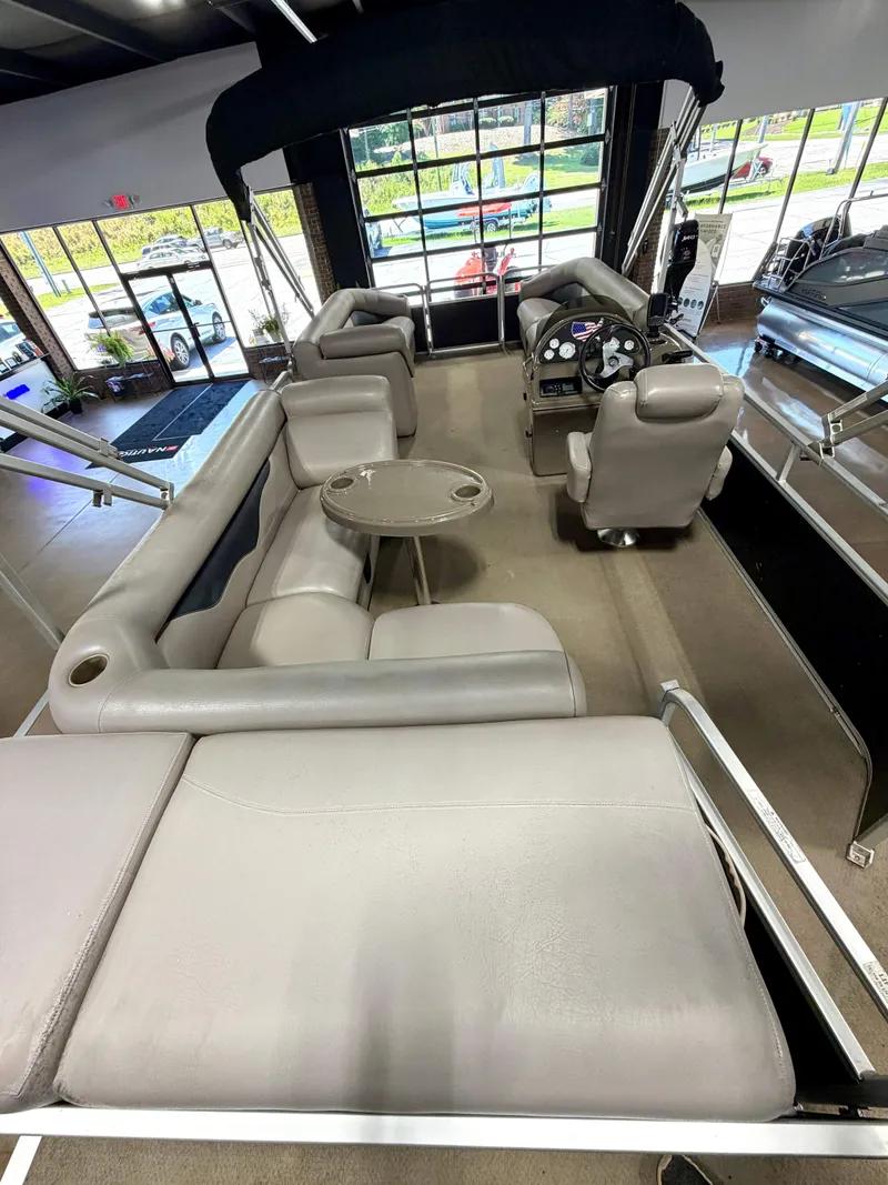 Slide: The Image of Interior of a 2011 Premier Sunsation 220 with gray seating and a small table. - 10