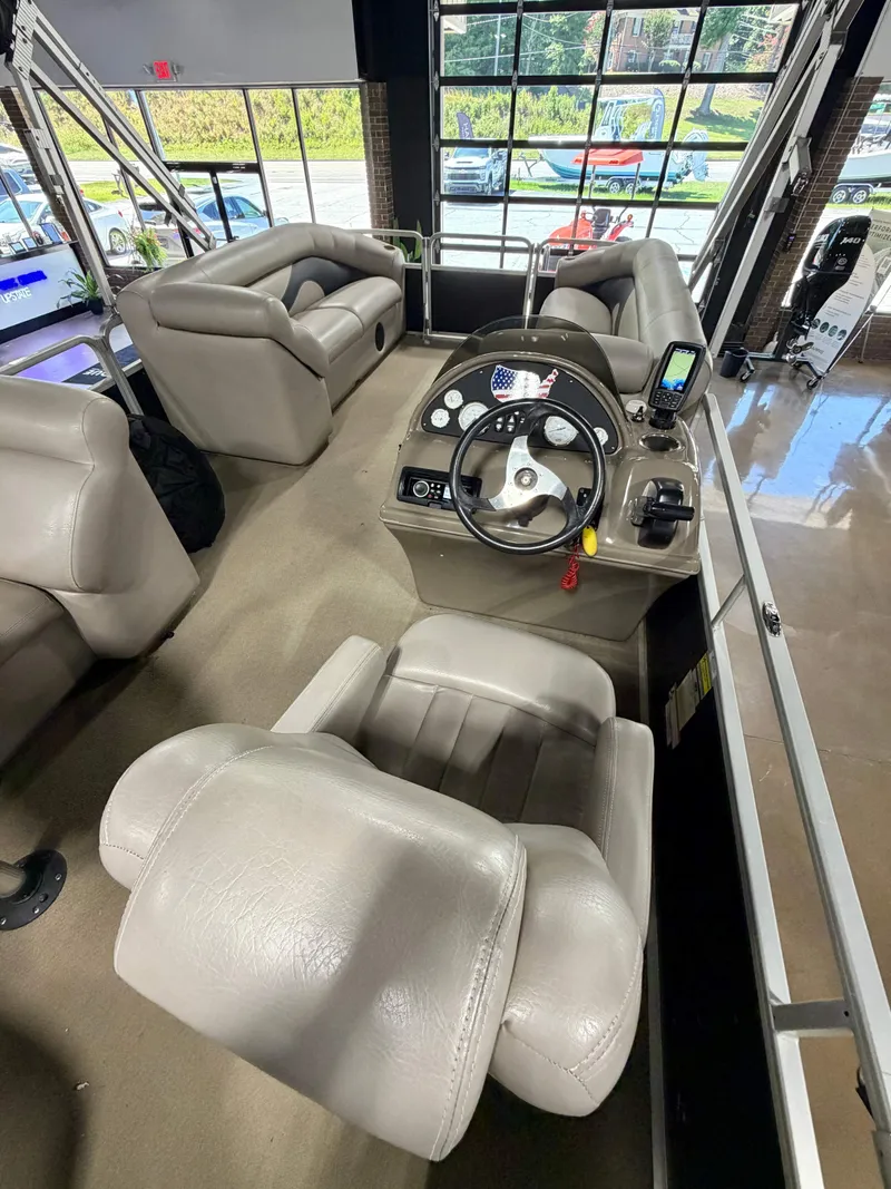 Slide: The Image of The image shows the cockpit of a 2011 Premier Sunsation 220 with beige leather seats and a modern helm. - 7