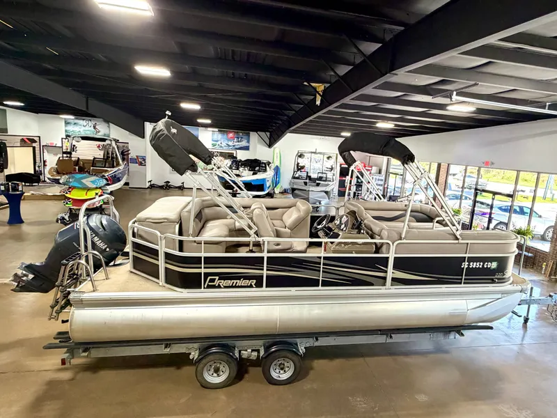 Slide: The Image of A 2011 Premier Sunsation 220 pontoon boat on a trailer in a showroom. - 4