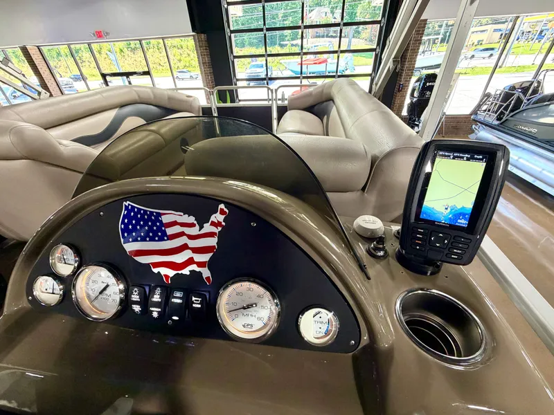 Slide: The Image of The image shows the dashboard of a Premier Sunsation 220 boat with a USA emblem. - 9