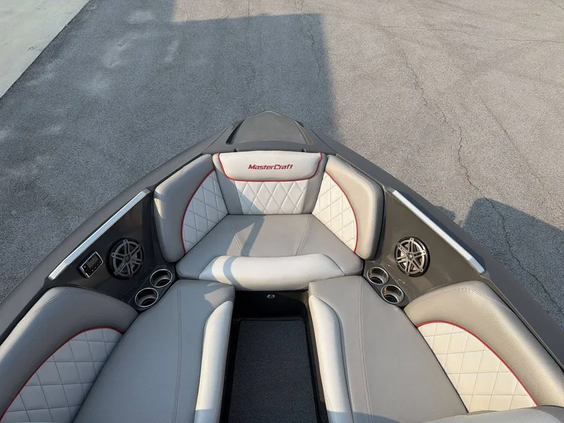 Slide: The Image of The image shows the bow of a 2015 MasterCraft X30 with gray and white upholstery. - 31